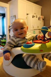 Hanging in my seat while Mom & Dad consume food in front of me... again.